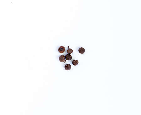 black pepper on a white background. Spices, seasoningの写真素材