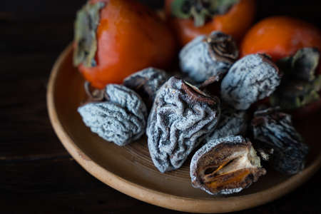 Dried persimmon on a wooden background. healthy diet. high quality photoの写真素材