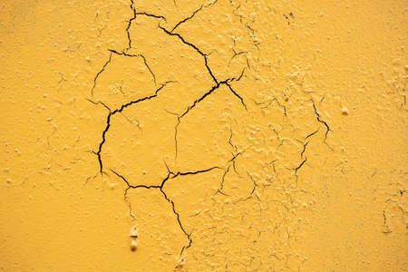 Cracked and damaged painted surface of a building or wall. Texture, aged paint background. high quality photoの写真素材