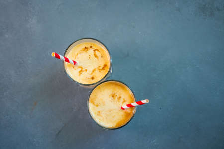 Yellow Indian mango yoghurt drink Mango Lassi or smoothie with turmeric and saffron. Healthy probiotic Indian cold summer drink.. High quality photoの写真素材