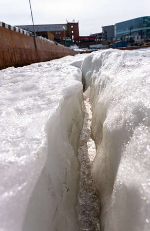 crack in the ice sheet. snow ice. Cracked ice floats on the sea. high quality photo