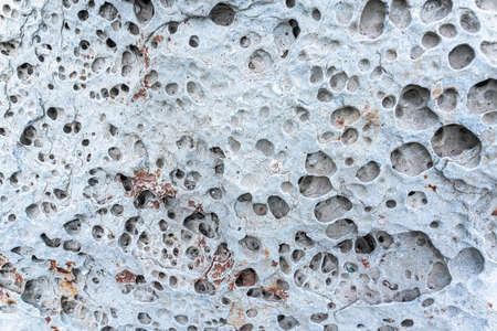 texture of porous stones on the beach, nature, natural phenomena, brown gray stones. high quality photoの写真素材