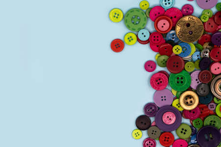 Colored sewing buttons composition on green pastel background. Flat lay with copy space. high quality photoの写真素材