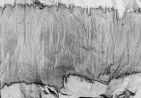 Crumpled and shiny silver paper background. high quality photoの写真素材