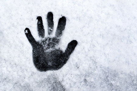 snowhand. One hand prints on fresh snow. winter day. high quality photoの写真素材
