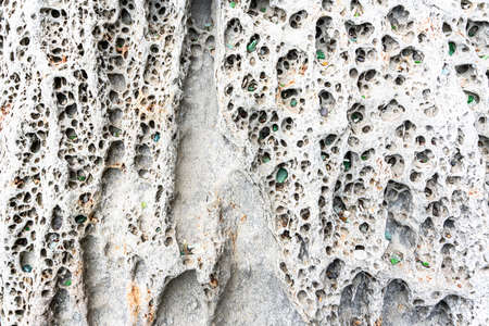 texture of porous stones on the beach, nature, natural phenomena, brown gray stones. high quality photoの写真素材