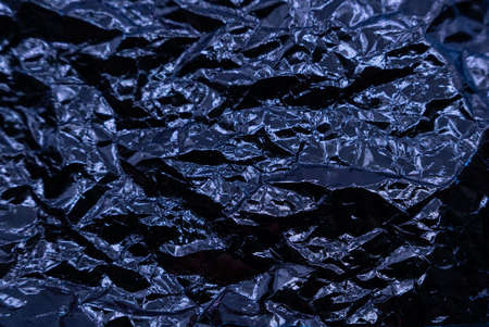 Crumpled very peri or violet foil background. abstract pattern. Trendy color of the Year 2022. High quality photoの写真素材