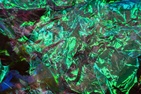 colorful grunge background. Rough texture. Neon light red green blue shiny wrinkled rock dark abstract art. high quality photoの写真素材