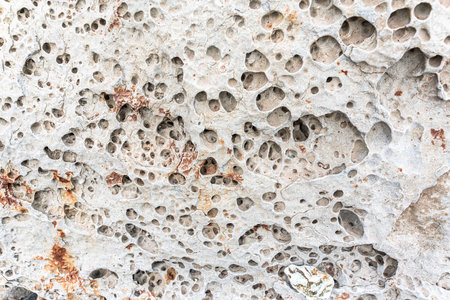 texture of porous stones on the beach, nature, natural phenomena, brown gray stones. high quality photoの写真素材