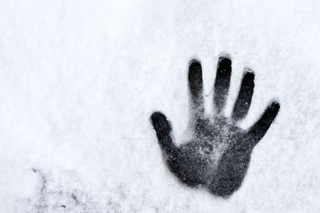 snowhand. One hand prints on fresh snow. winter day. high quality photoの写真素材