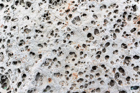 texture of porous stones on the beach, nature, natural phenomena, brown gray stones. high quality photoの写真素材