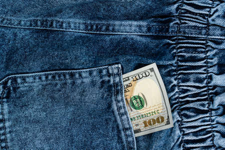 One hundred dollar bills in the back pocket of jeans. money in pocket concept. cash. high quality photoの写真素材