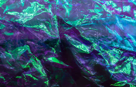 colorful grunge background. Rough texture. Neon light red green blue shiny wrinkled rock dark abstract art. high quality photoの写真素材