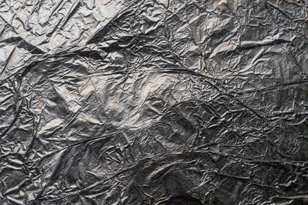 Crumpled and shiny silver paper background. high quality photoの写真素材