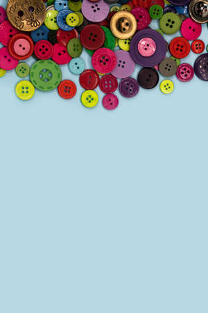 Colored sewing buttons composition on green pastel background. Flat lay with copy space. high quality photoの写真素材