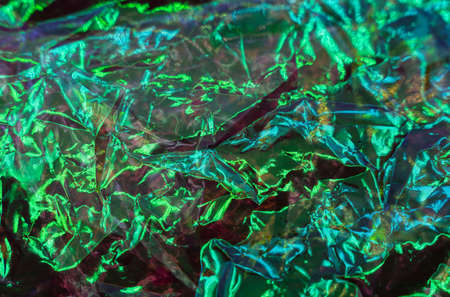 colorful grunge background. Rough texture. Neon light red green blue shiny wrinkled rock dark abstract art. high quality photoの写真素材