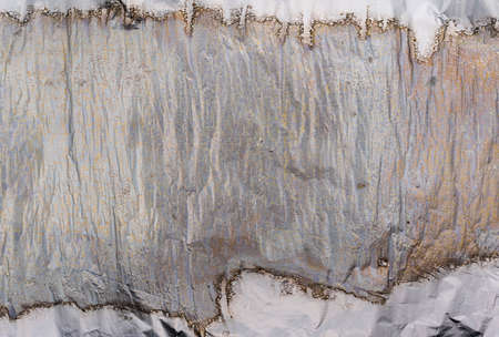Crumpled and shiny silver paper background. Crumpled foil textureの写真素材