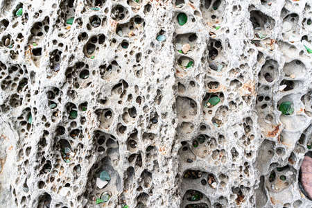 texture of porous stones on the beach, nature, natural phenomena, brown gray stonesの写真素材