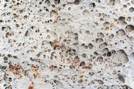 texture of porous stones on the beach, nature, natural phenomena, brown gray stones. high quality photoの写真素材