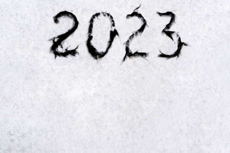 numbers 2023 paint handwritten on flour brown table. high quality photoの写真素材