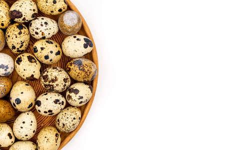 Uncooked scattered Quail eggs on white background top view, healthy food concept. high quality photoの写真素材