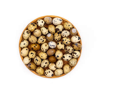 Uncooked scattered Quail eggs on white background top view, healthy food concept. high quality photoの写真素材
