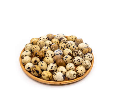 Uncooked scattered Quail eggs on white background top view, healthy food concept. high quality photoの写真素材