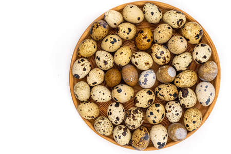 Uncooked scattered Quail eggs on white background top view, healthy food concept. high quality photoの写真素材