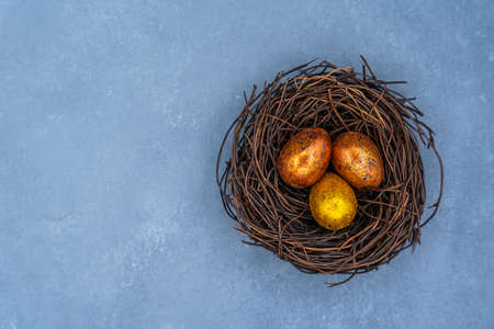 Easter background with golden and colored eggs. Happy easter background top view. high quality photoの写真素材