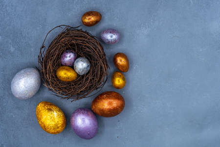 Easter background with golden and colored eggs. Happy easter background top view. high quality photoの写真素材