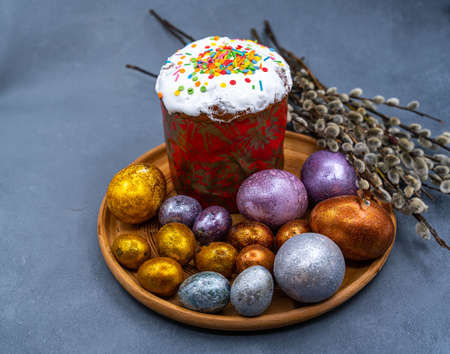Happy Easter bread. Festive cake with traditional decor. Eggs, willow, trendy hard light, dark shadow.High quality photoの写真素材