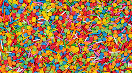 Dots of sugar sprinkles, cake and pastry decoration, lots of sprinkles as a background. high quality photoの写真素材
