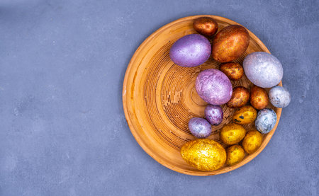 Easter background with golden and colored eggs. Happy easter background top view. high quality photoの写真素材