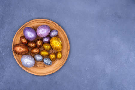 Easter background with golden and colored eggs. Happy easter background top view. high quality photoの写真素材