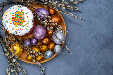 Happy Easter bread. Festive cake with traditional decor. Eggs, willow, trendy hard light, dark shadow.High quality photoの写真素材