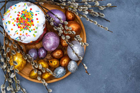 Happy Easter bread. Festive cake with traditional decor. Eggs, willow, trendy hard light, dark shadow.High quality photoの写真素材