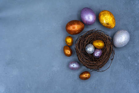Easter background with golden and colored eggs. Happy easter background top view. high quality photoの写真素材