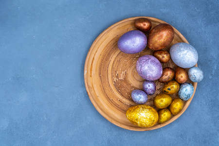 Easter background with golden and colored eggs. Happy easter background top view. high quality photoの写真素材