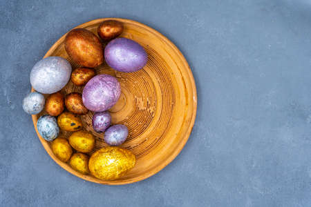 Easter background with golden and colored eggs. Happy easter background top view. high quality photoの写真素材
