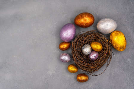 Easter background with golden and colored eggs. Happy easter background top view. high quality photoの写真素材