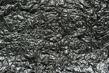 Abstract texture pattern metallic paper using as a background or wallpaper. Metal aluminum foil shiny and reflectorの写真素材