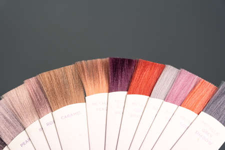 Samples of professional hair dye in a hairdressing salon. Hair coloring in a beauty salon. Hair dye kit on board with hair samples of different colors. high quality photoの写真素材