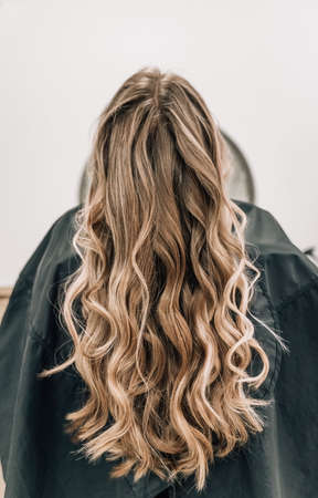 Close-up of a bun of shiny blonde hair curls. high quality photoの写真素材