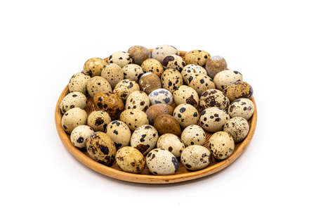 Uncooked scattered Quail eggs on white background top view, healthy food concept. high quality photoの写真素材