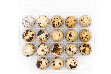 Uncooked scattered Quail eggs on white background top view, healthy food concept. high quality photoの写真素材