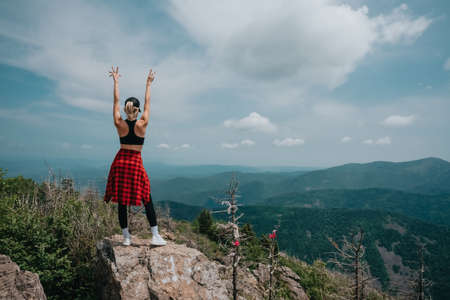 A girl on top of Falaza mountain looks at a beautiful mountain valley. Travel and tourism. Hiking High quality photoの写真素材