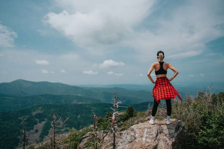 A girl on top of Falaza mountain looks at a beautiful mountain valley. Travel and tourism. Hiking High quality photoの写真素材