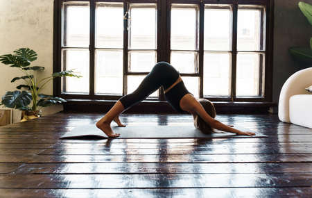 A young girl in sportswear does yoga, fitness at home, sports at home, stretching. high quality photoの写真素材