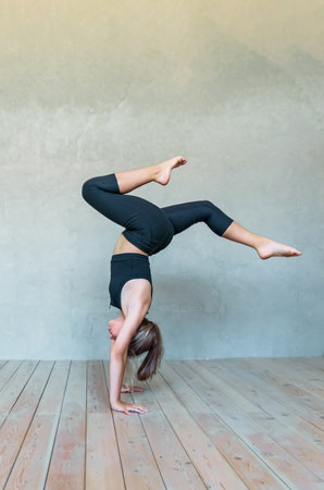A young girl in sportswear does yoga, fitness at home, sports at home, stretching. high quality photoの写真素材