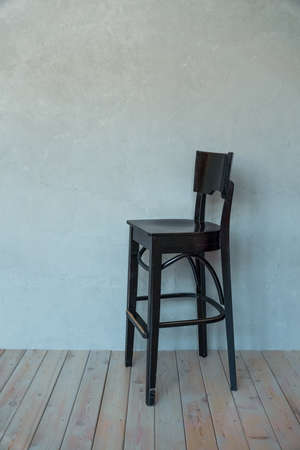 Wooden comfortable, high chair on a gray background. high quality photoの写真素材